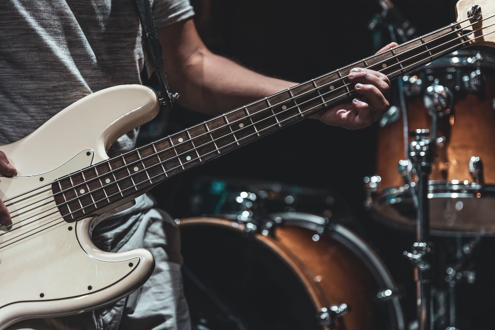 Baixista tocando perto de bateria
